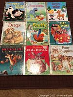 Front covers of 9 children's books laid out including Little Golden Books titles like The Poky Little Puppy, Grover's Guide to Good Manners, Rudolph the Red-Nosed Reindeer, Dogs, Scuffy the Tugboat, The Fire Engine, The Golden Egg Book, and Four Puppies.