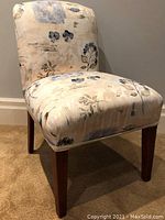 Front-right angle view showing seat, backrest, and wooden legs with minor scratches.