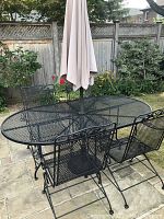 Full set view with table, four chairs and umbrella inserted