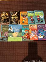 Top-down photo of 10 paperback books laid out in two rows, showing front covers.