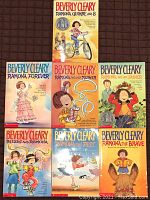 Photo showing front covers of all seven Beverly Clearly Ramona paperback books with colorful illustrated cartoon-style covers.
