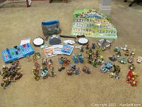 Overview of all Skylanders game pieces, portals, trophies, posters, stickers, and carry case spread on floor.
