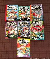 Seven Captain Underpants books including issues #1, 2, 3, 6, 7, 9 and Extra Crunchy Book of Fun, all with colorful comic-style covers.