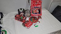 Photo showing Coca-Cola holiday collectible items including cookie plate, tumbler, ornament, puzzle in original box, and ice cube tray.