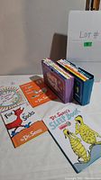 Books displayed on table showing titles and colorful covers.