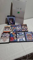10 assorted hockey VHS and DVD tapes laid out on a table including a tape titled Ultimate Gretzky and others with NHL content
