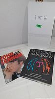 Two John Lennon hardcover books side by side with a white box behind labeled Lot # 72.