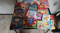 Overview of toddler books and backpack on table showing colorful covers