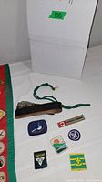 Full view of all items including sash with merit badges, patches, belt, and accessories