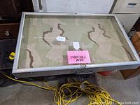 Top view of the rectangular display cabinet showing the aluminum frame and glass top with interior fabric lining.