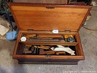 Open chest view showing removable tray and bottom compartment filled with hand tools