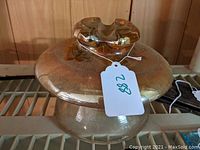 Full view of large carnival glass insulator showing its shape and coloring.