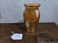 Marigold tree bark carnival glass vase displayed on wooden table with tag 29 shown at the side.