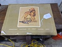 Closed portfolio with dog illustration and title Remington's Portfolio of Great Hunting Dogs, showing some corner wear and tear.