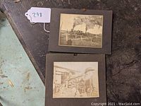 Two mounted black and white photographs on a dark surface showing railroad scenes.