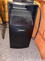 Bose large subwoofer speaker with front-facing port and Bose logo, black.