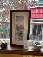 Full view of framed silk scene picture and carved stone bowl on windowsill