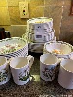 Overall view of stacked plates and mugs on countertop