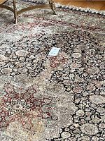 Central section of rug showing eight-pointed floral medallion and surrounding vine motifs.