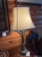 Photo of the first brass lamp with rectangular cream shade and decorative base