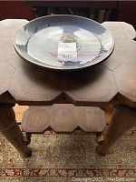 View of table with ceramic plate on top, showing overall scale and appearance.