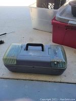 Closed plastic carrying case with handle.