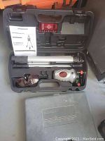 Open carrying case including Pittsburgh branded self-leveling laser level, adjustable tripod, laser glasses, user manual, and black plastic carrying case lid.