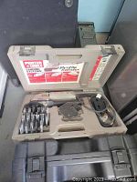 Porter Cable profile sander and sanding system case opened to show sander, power cord, and sanding accessories inside.