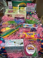 Frontal view of basket contents showing multiple craft kits and supplies.
