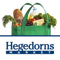Green reusable shopping bag filled with groceries and Hegedorn's Market logo indicating the store brand for the gift card.