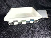 Photo of side view showing black and white checkered pattern on the enamel baking pan.