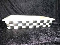 Side view of rectangular enamel baking pan showing black and white checkered pattern around the rim and sides.