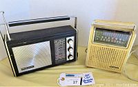 Two vintage radios side by side on a neutral background, a black Magnavox and beige Panasonic, clearly showing front speaker grills, tuning dials, and carry handles.