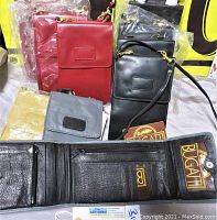 Photo showing set of 10 Bugatti leather purses and wallets in assorted colors with tags and packaging