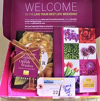 Top view of gift box opened showing two books packed inside along with a tag.