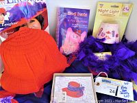 Lot items displayed together showing red scarf, purple feather boa, night light, note cards, and cocktail recipe book.