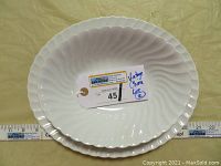 Oval white ceramic platter with swirl design, approx. 11.5 x 9.75 inches