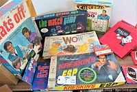 Photo showing the collection of vintage boxed games from Hats Off to Kreskin's ESP, highlighting the box artwork and condition.
