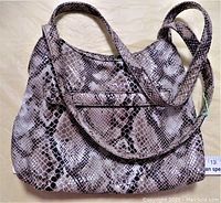 Front view of the snakeskin pattern vintage handbag showing strap and front pocket detail.