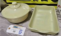 Overhead angled view of the 8" round casserole dish with lid and rectangular loaf pan, ivory cream color, showing shape and condition