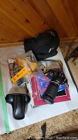 Overview of camera, bag, case, film boxes, and book