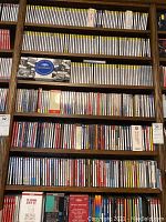 Multiple shelves filled with rows of individual jewel-case CDs