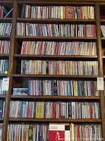 Full view of several shelves packed with jewel-case CDs across six rows.