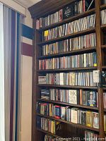 Full view of wooden shelving filled with classical CDs on multiple shelves