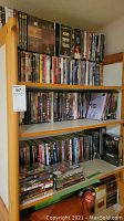 Full shelving unit holding rows of standard DVD cases