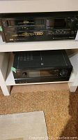 Front view of Mitsubishi FX4 Super Editing VHS VCR with labeling showing 1.6MB/s FE Head Twin Digital U80 tape support and button controls.
