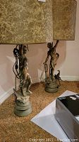 Front view of both lamps side by side showing full height, bases, figures and matching shades