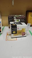 Boxed Paderno Spiral Slicer and Marcato Atlas 150 Wellness pasta maker on white table surface.