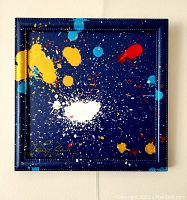 Front view showing vibrant splattered paint colors on dark blue background with artist signature visible