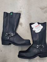 Side view of the black steel toe harness boots showing the harness strap design and block heel.